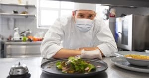 Resuming business: health, safety and pandemic concept - male chef cook